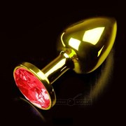 Маленькая золотистая анальная пробка с круглым кончиком и красным кристаллом - 7 см. Пикантные штучки фотография