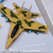 Игрушка самолет военный музыкальный инерционный 1 шт желтый с пятнами фото