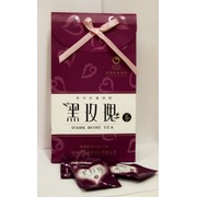 Темный чай с розой в подарочной упаковке фотография